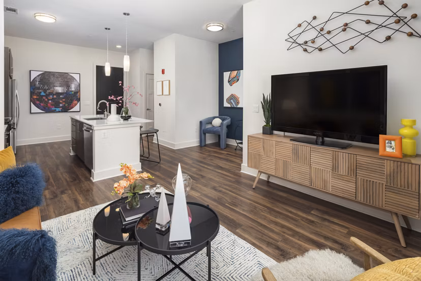 Spacious living room with modern decor and large windows at 675 N Highland Apartments, luxury residence for urban living