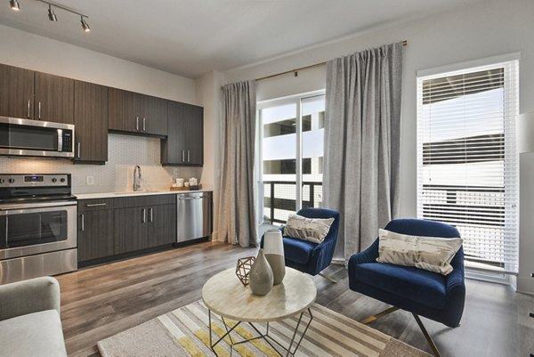 Spacious living room with modern decor and large windows at 675 N Highland Apartments, luxury residence for urban living