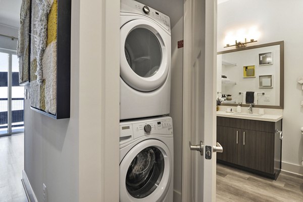 Laundry room featuring modern washers and dryers at 675 N Highland Apartments