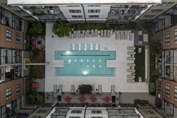 Sparkling pool with sun loungers at 675 N Highland Apartments, a Greystar luxury community