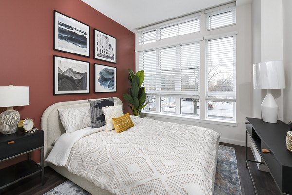 Bedroom featuring stylish decor and ample natural light at Alta 801 Apartments