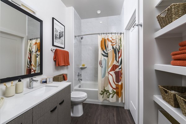 Elegant bathroom featuring sleek fixtures and marble countertops at Alta 801 Apartments