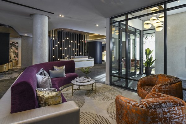 Clubhouse featuring elegant seating and modern decor at Alta 801 Apartments, a luxury community by Greystar