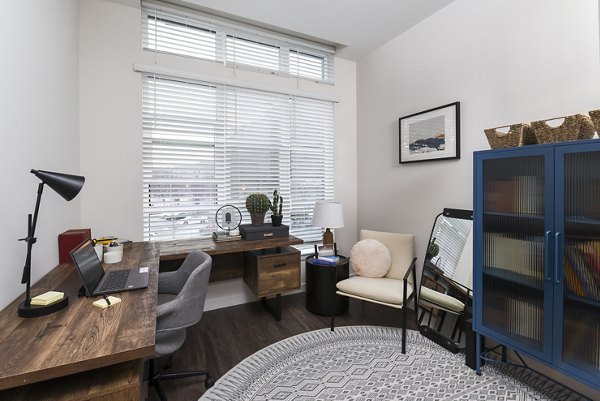Modern home office with ergonomic chair and built-in desk at Alta 801 Apartments