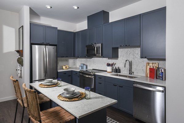 Modern kitchen with stainless steel appliances at Alta 801 Apartments