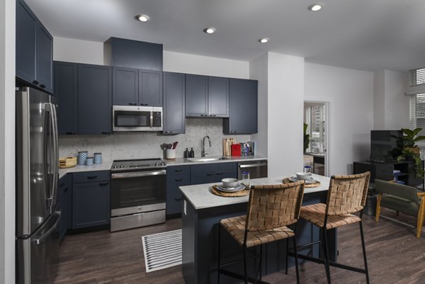 Modern kitchen featuring stainless steel appliances at Alta 801 Apartments