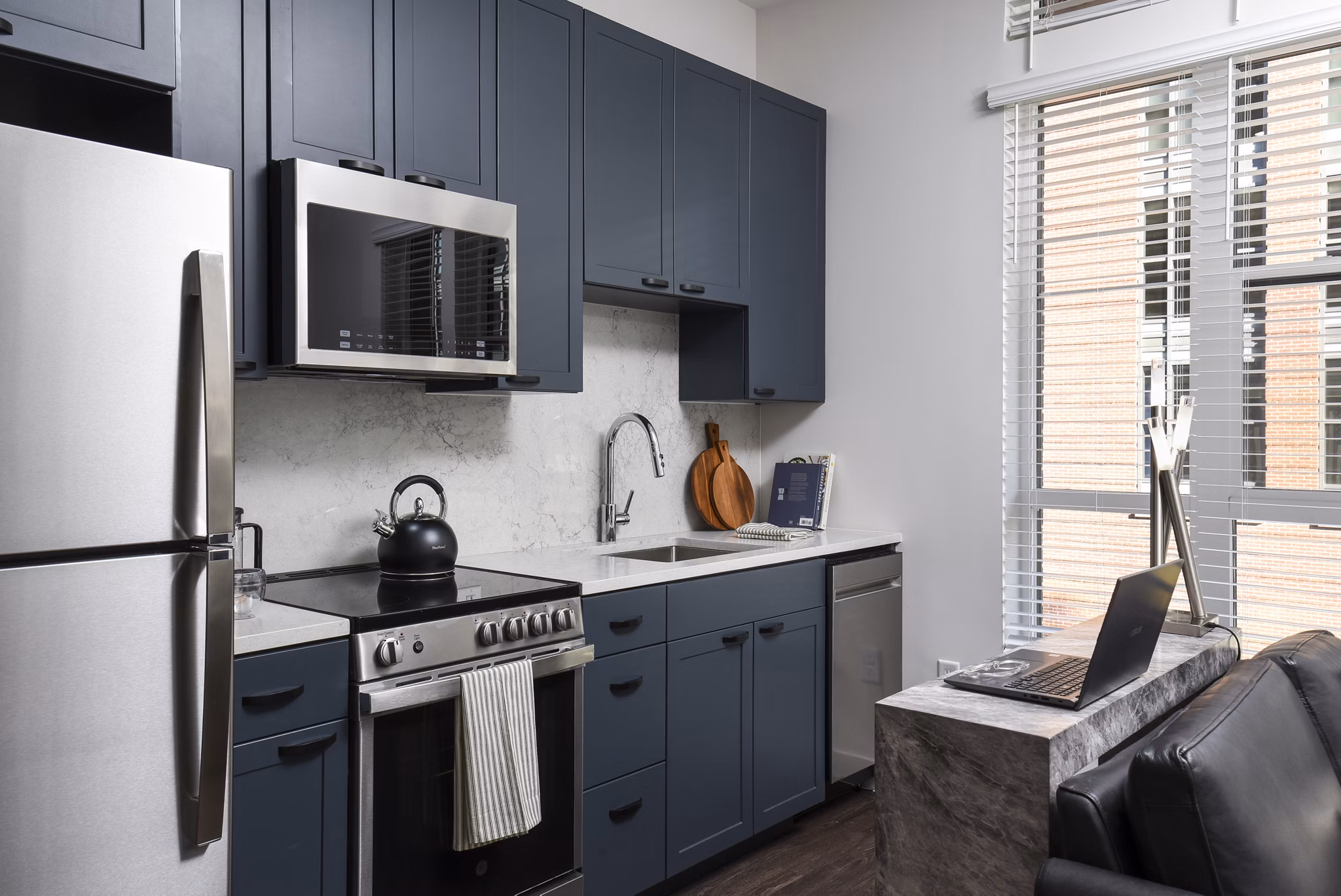 Contemporary kitchen with modern appliances at Alta 801 Apartments in spacious luxury setting