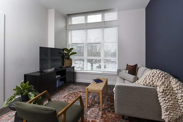 Spacious living room with modern decor and ample natural light at Alta 801 Apartments