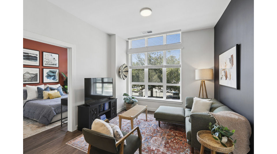 Spacious living room with modern decor and ample natural light at Alta 801 Apartments