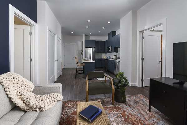 Living room featuring modern decor and cozy seating at Alta 801 Apartments luxury units
