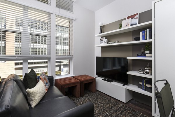 Living room showcasing modern decor and natural light at Alta 801 Apartments