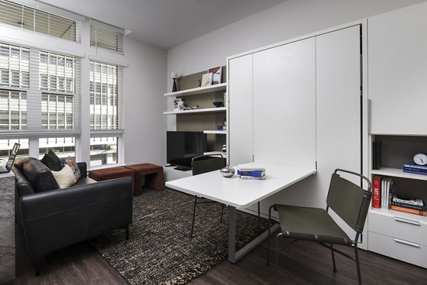 Modern living room with plush seating and large windows at Alta 801 Apartments, offering luxury and comfort in a premier setting