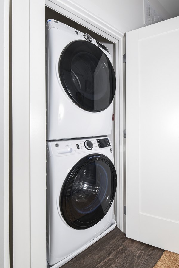 Laundry room equipped with modern washers and dryers at Alta 801 Apartments