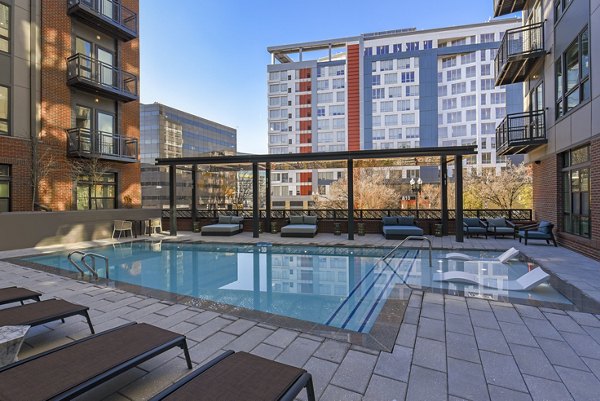 Rooftop swimming pool with lounge seating at Alta 801 Apartments offering luxury amenities and skyline views