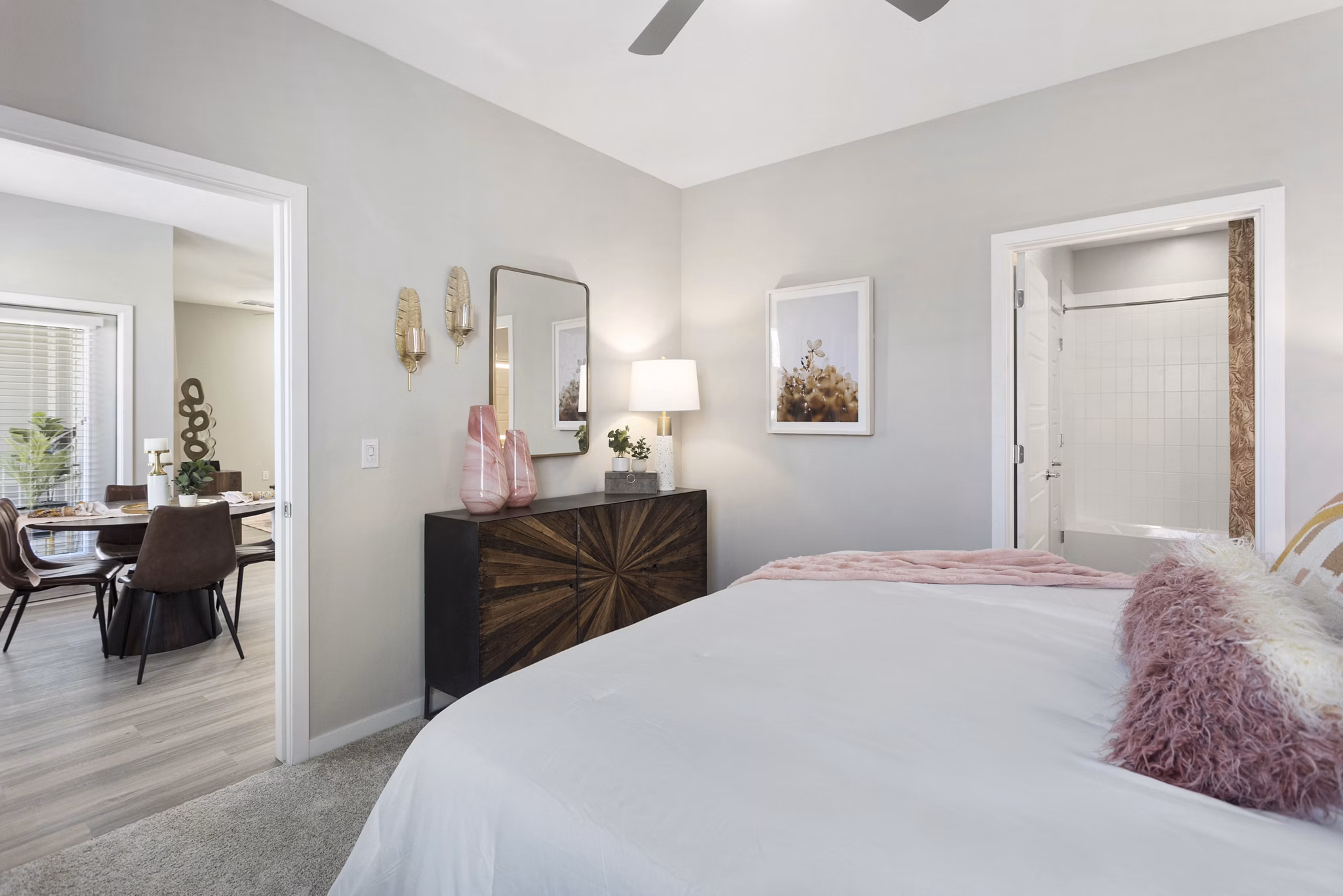 Bedroom with modern decor at Alta 99th Ave Apartments featuring plush bedding and natural light