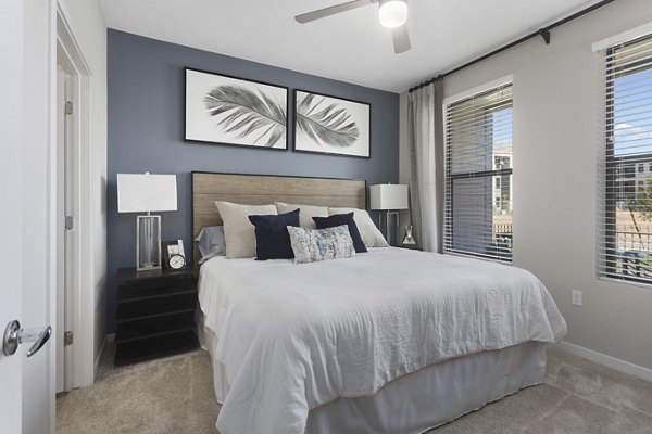 Cozy bedroom featuring contemporary decor and natural light at Alta 99th Ave Apartments