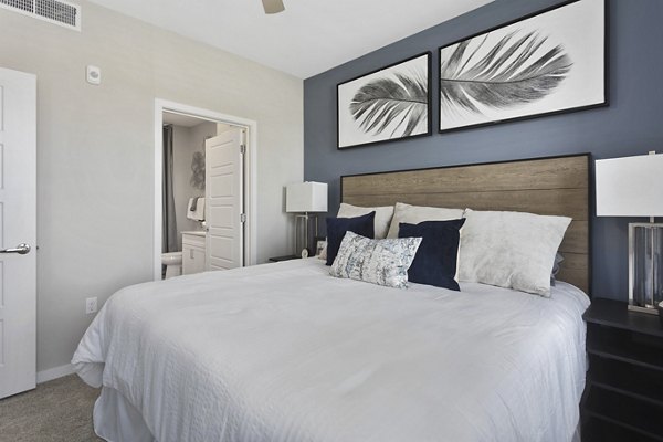 Cozy bedroom with modern design elements at Alta 99th Ave Apartments