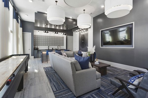 Clubhouse featuring modern design and spacious seating at Alta 99th Ave Apartments