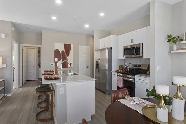 Dining area with elegant lighting and modern furnishings in Alta 99th Ave Apartments