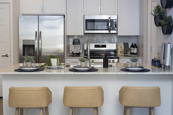 Stylish kitchen with modern appliances at Alta 99th Ave Apartments