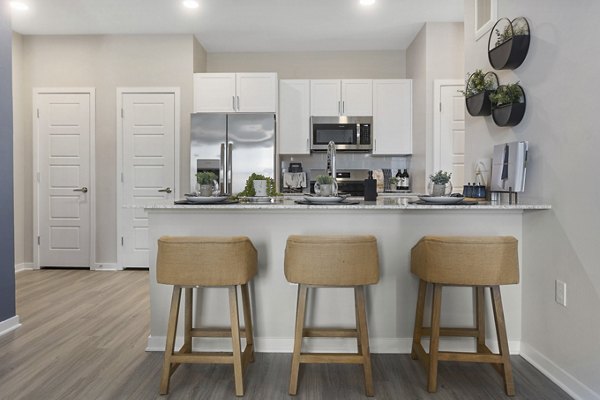 Modern kitchen with stainless steel appliances at Alta 99th Ave Apartments, showcasing luxury living spaces in Phoenix