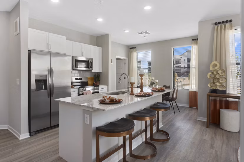 Modern kitchen with stainless steel appliances in Alta 99th Ave Apartments