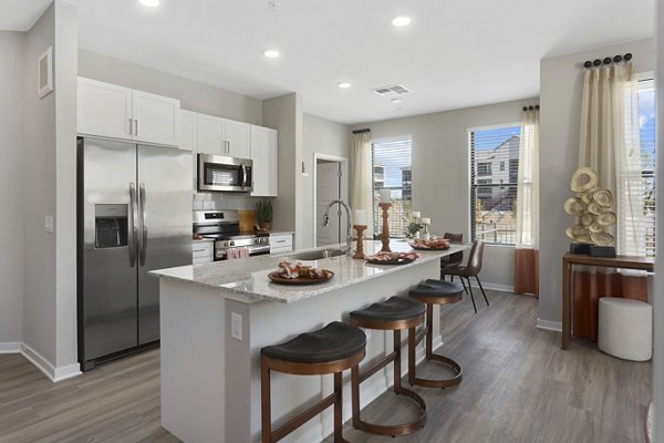 Modern kitchen with stainless steel appliances in Alta 99th Ave Apartments