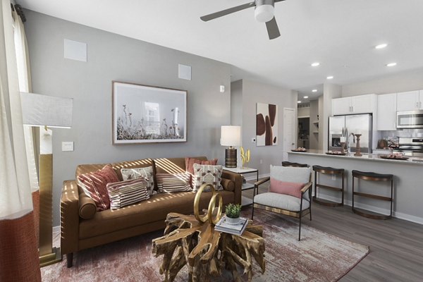 Living room with modern decor and large windows at Alta 99th Ave Apartments