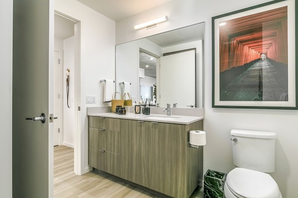 Modern bathroom with white countertops and sleek fixtures in Alta ART Tower Apartments