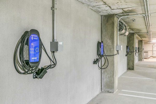 Electric car charging station at Alta ART Tower Apartments featuring modern green energy solutions