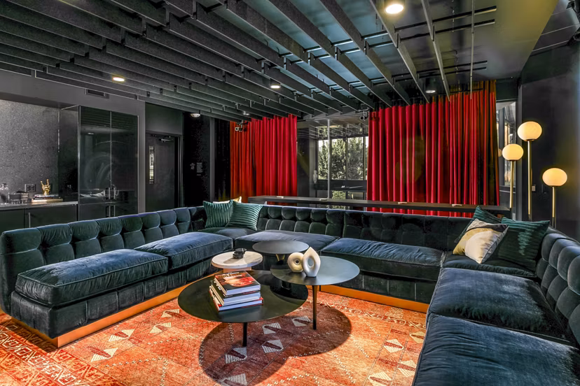 Elegant clubhouse lounge at Alta ART Tower Apartments with modern decor and ample seating