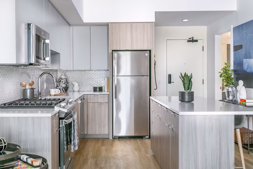 Modern kitchen with stainless steel appliances in Alta ART Tower Apartments, offering luxury living spaces in the heart of the city
