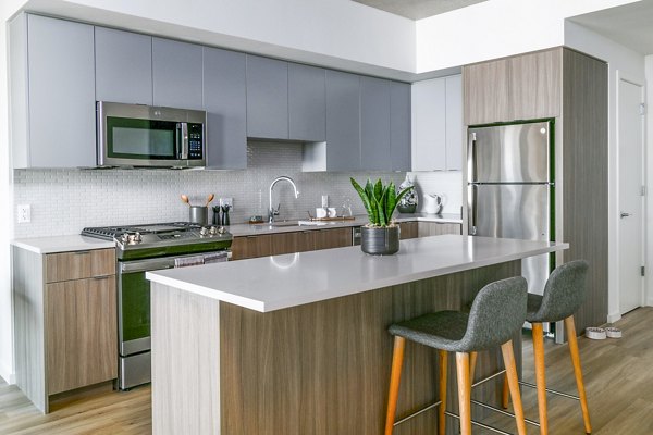 Modern kitchen with stainless steel appliances at Alta ART Tower Apartments