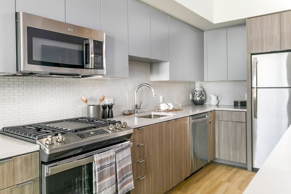 Modern kitchen with sleek appliances at Alta ART Tower Apartments