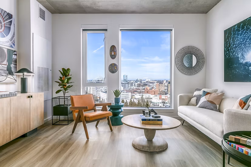 Living room with modern decor and large windows at Alta ART Tower luxury apartments