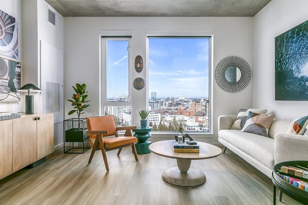 Living room with modern decor and large windows at Alta ART Tower luxury apartments