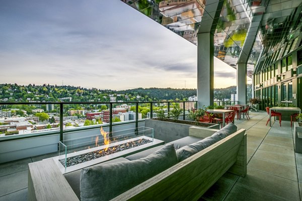 Fire pit and cozy outdoor patio at Alta ART Tower Apartments, perfect for relaxation and social gatherings