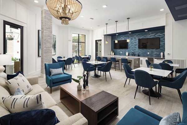 Clubhouse at Alta Ashley Park Apartments featuring modern design and cozy seating areas in luxury residence