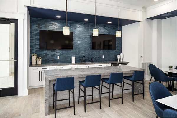 Clubhouse featuring stylish interiors and modern seating areas at Alta Ashley Park Apartments, a luxury community by Greystar