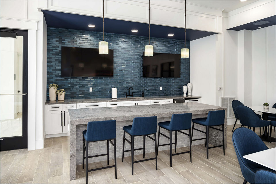 Clubhouse featuring stylish interiors and modern seating areas at Alta Ashley Park Apartments, a luxury community by Greystar