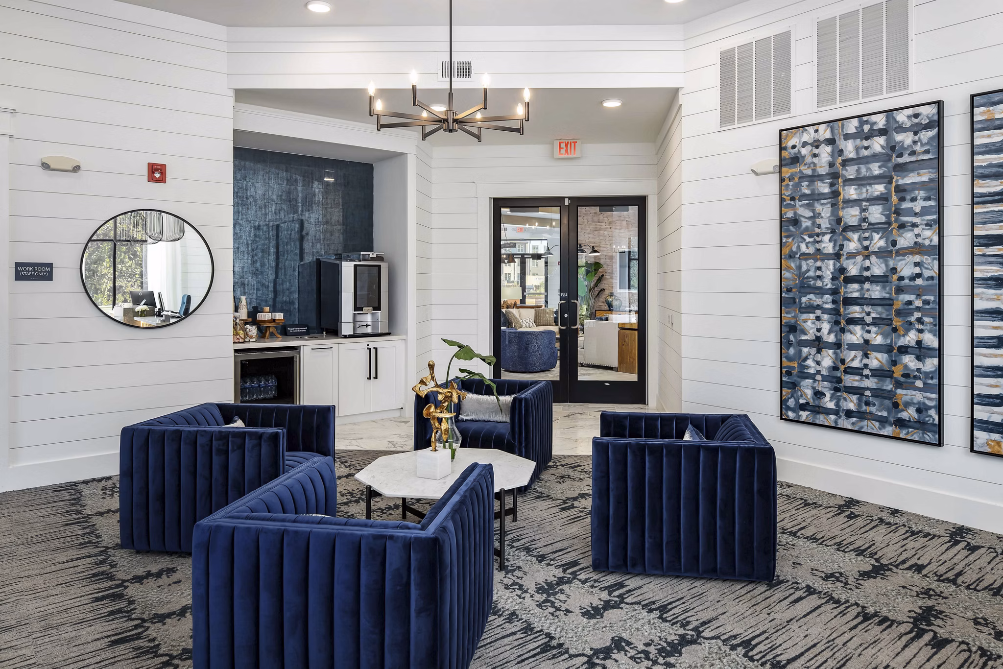 Clubhouse with modern decor and lounge seating at Alta Ashley Park Apartments, highlighting luxury living spaces in a vibrant community setting