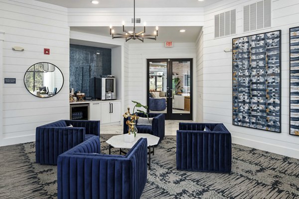 Clubhouse with modern decor and lounge seating at Alta Ashley Park Apartments, highlighting luxury living spaces in a vibrant community setting