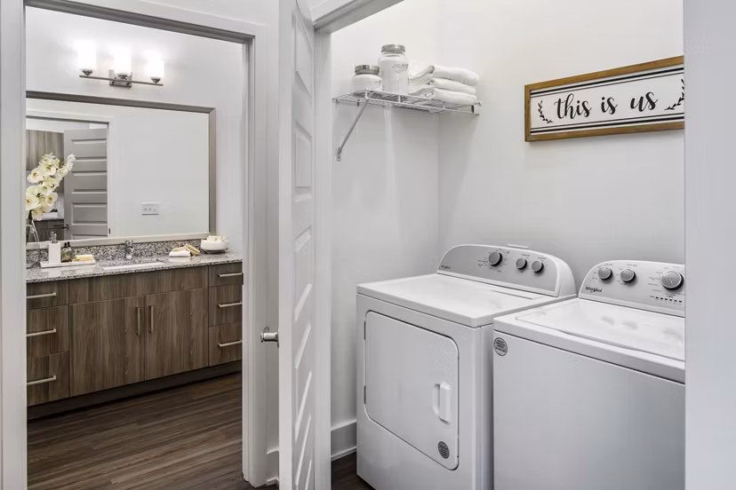 Laundry room featuring modern appliances at Alta Ashley Park Apartments