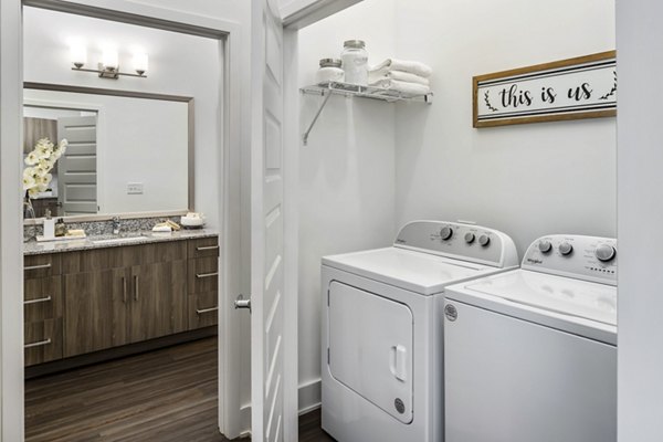 Laundry room featuring modern appliances at Alta Ashley Park Apartments