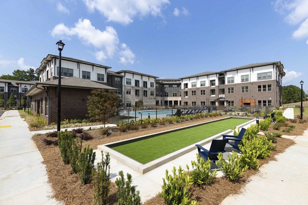 Recreation area with outdoor seating and green spaces at Alta Ashley Park Apartments
