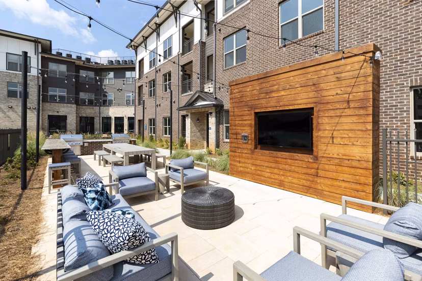 Recreation area featuring modern seating and game tables at Alta Ashley Park Apartments