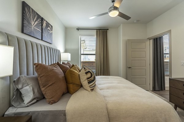 Bedroom with cozy layout and stylish decor at Alta Berry Creek Apartments