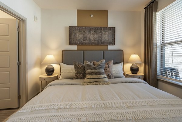 Cozy bedroom with modern furnishings at Alta Berry Creek Apartments, offering a luxury living experience in a desirable location