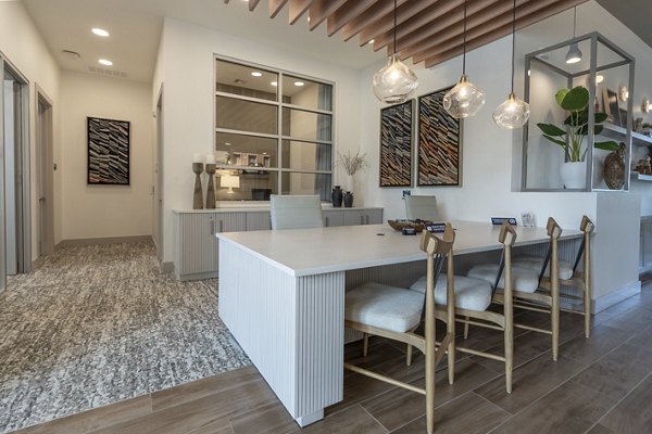Clubhouse with modern seating and fireplace at Alta Berry Creek Apartments, a luxury community offering premier amenities and stylish interiors