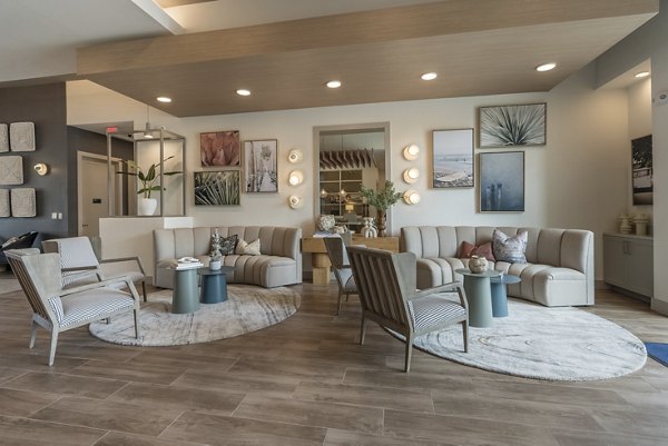 Clubhouse with modern design at Alta Berry Creek luxury apartments featuring comfortable seating and a spacious lounge area